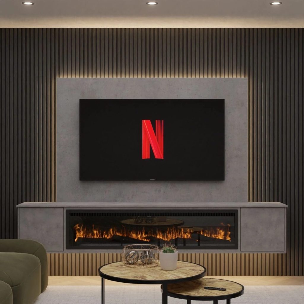 Modern living room media wall with wall mounted TV above a fireplace display unit with acoustic slat panels - Cornwall Media Walls